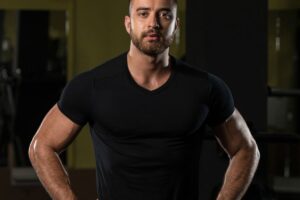 A-man-is-wearing-a-black-V-neck-athletic-t-shirt